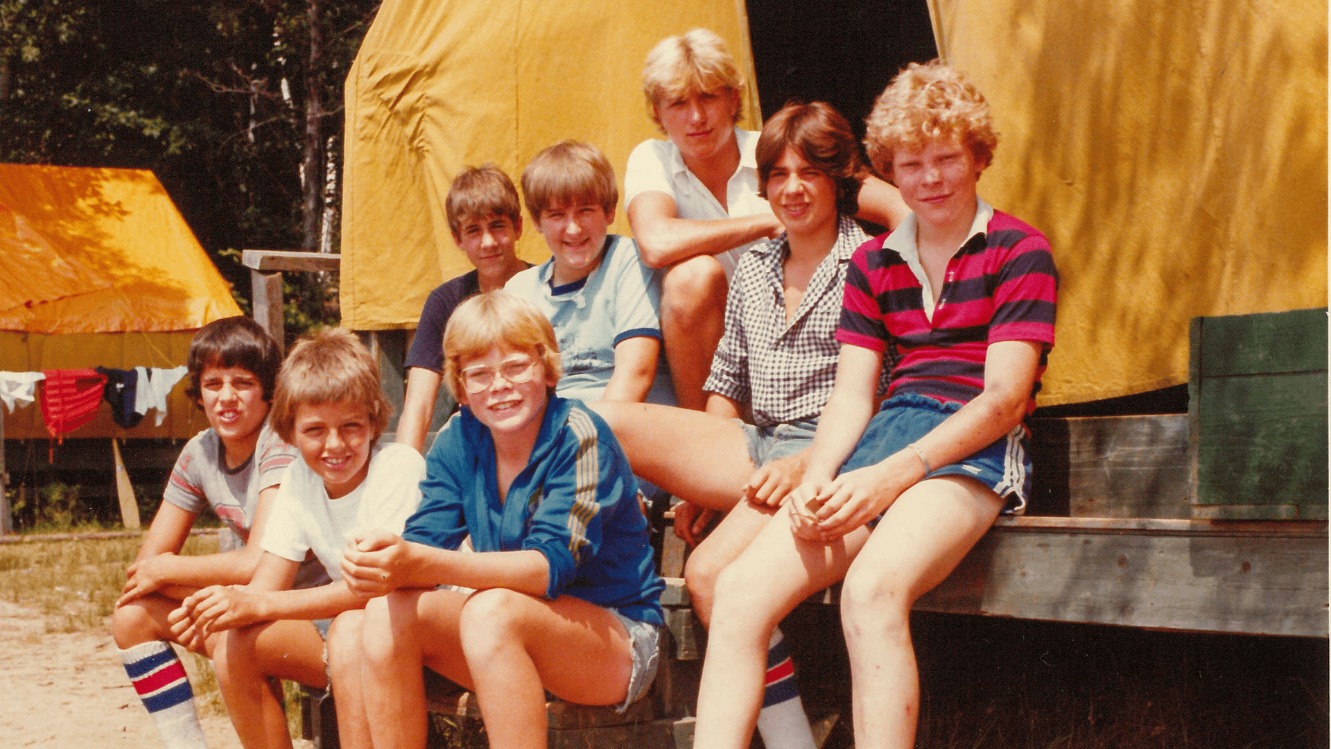 Vintage color photo of boys sitting together on a bench.