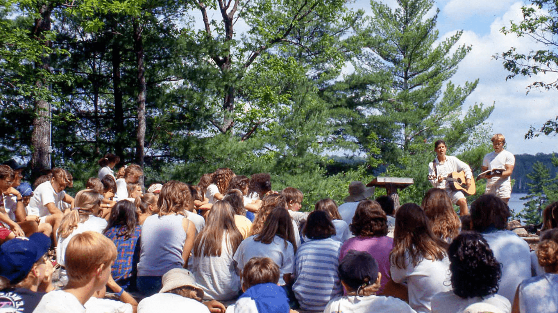 A large crowd of people watching an outdoor event.