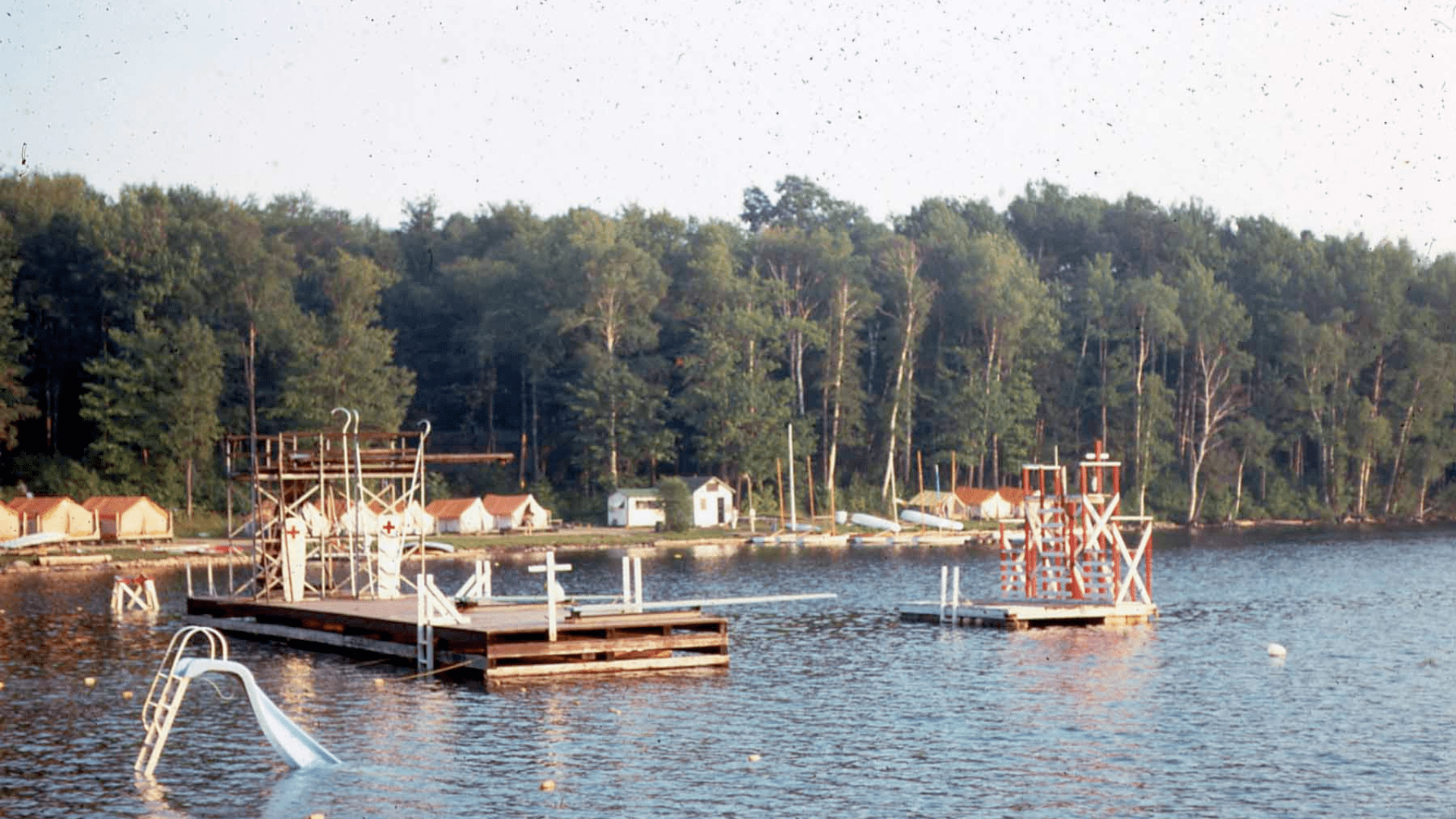 A view of a wooden dock on a calm lake.